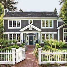 a large house with a white picket fence