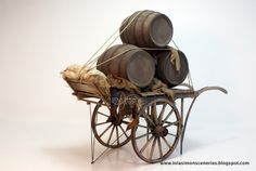 an old fashioned wooden wagon with barrels on it