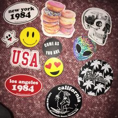 various stickers and decals from the past, including donuts, smiley faces, palm trees, usa, new york, u s c