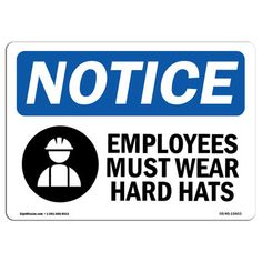 a blue and white sign that says notice hard hats must be worn in this area