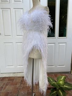 a mannequin with white feathers on it