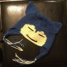 a crocheted hat with a smiling cat on it