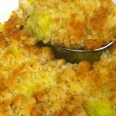 a close up of a plate of food with broccoli and bread crumbs