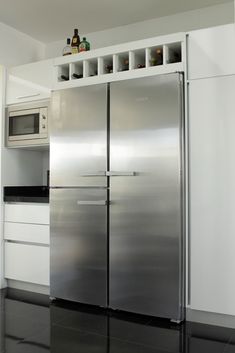 a stainless steel refrigerator freezer sitting inside of a kitchen