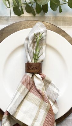 a white plate topped with a plaid napkin