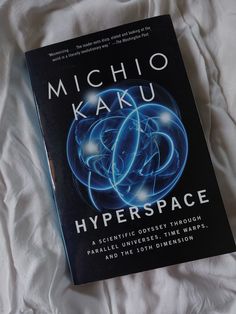 the book cover for hyperspace by michio kaku is laying on a bed