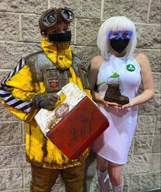 two people dressed in costumes standing next to each other