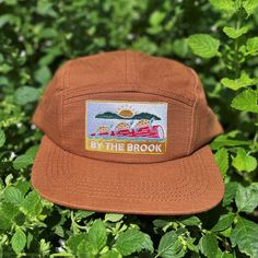 "This \"By The Brook\" flat brim, five panel camper style cap has a turtle and sun embroidered patch and a nylon strap clip closure. Comfortable and classic! * Soft-structured (made of cotton) * Color: Brown Rust * Five panel * Low profile * Nylon strap clip closure * Made by fermentation enthusiasts * The perfect gift for outdoorsy and stylish friends!" Olive Green Hat, Camper Hat, Five Panel Hat, Camping Vintage, Classic Campers, Hiking Hat, Flat Brim Hat, Camp Style, Five Panel