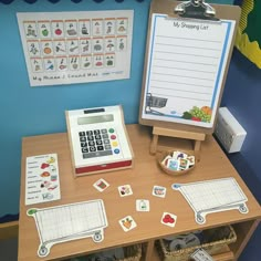 a wooden desk topped with lots of magnets next to a dry eraser and a calculator