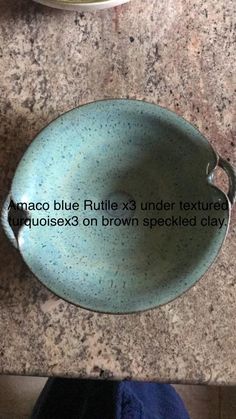 a blue plate sitting on top of a counter next to a bowl