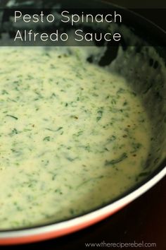 a bowl filled with pesto spinach alfredo sauce