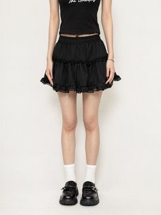 Exude confidence with every step in this moody Layered Ruffle Mini Skirt with Lace Trim, where edgy meets delicacy in perfect harmony. Crafted from soft, breathable cotton, this skirt is as comfortable as it is stylish. The intricate lace trim and cascading ruffled layers generate a uniquely textured silhouette that's both flirty and sophisticated. Its high-waisted design ensures a flattering fit, while the A-line cut offers ease of movement, making it an ideal choice for those spontaneous outin Edgy Flowy Skirt For Spring, Edgy Tiered Skirt With Ruffles, Edgy Ruffled Skirt Bottoms, Edgy Pleated Summer Skirt, Edgy Pleated Skirt For Summer, Edgy Ruffled Skirt For Spring, Edgy Relaxed Summer Skirt, Edgy Skirted Skort For Spring, Edgy Ruffled Skirt Bottoms For Spring