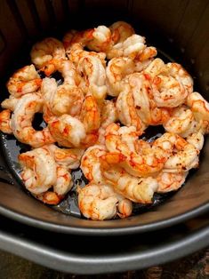 cooked shrimp in an air fryer basket ready to be cooked for dinner or lunch