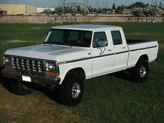 a white pick up truck parked in the grass