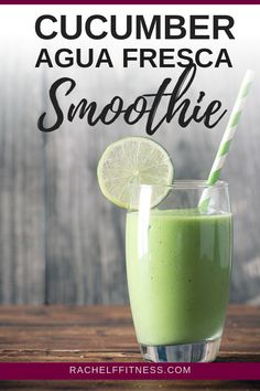 a green smoothie in a glass with a lime slice on the rim and a striped straw