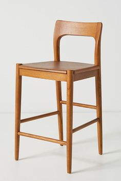 a wooden chair sitting on top of a white floor