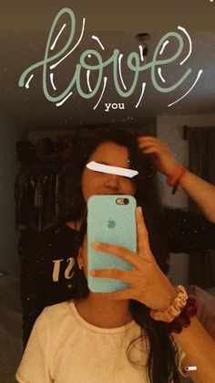 a woman taking a selfie in front of a mirror with the words love you on it