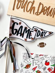 the game day sign is next to some football themed paper and wood signs that say touch down