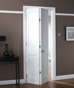 an open white door in a brown room