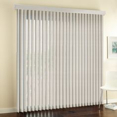 white vertical blinds in a living room with hardwood flooring and hard wood flooring