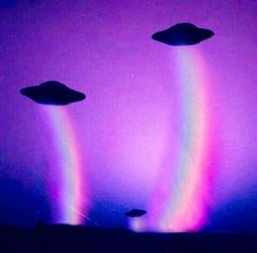 two alien like objects in the sky with rainbows and black spots on them,