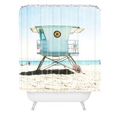 a shower curtain with a lifeguard tower on the beach