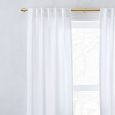 a white curtain hanging in front of a window