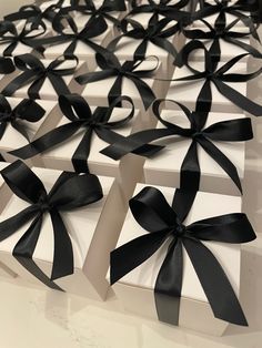 several white boxes with black bows on them