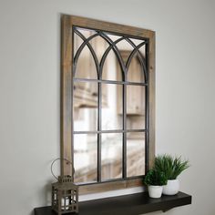 a shelf with a potted plant sitting on top of it next to a window