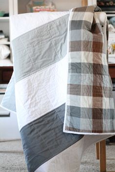 a white and brown blanket sitting on top of a table