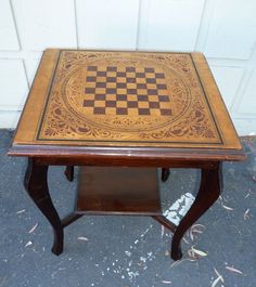 a small wooden table with a chess board on it's top and bottom edge