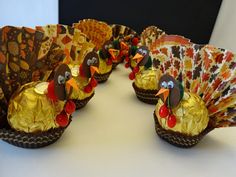 there are many small turkeys made out of candy wrappers on the table together