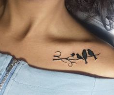 a woman's shoulder with two birds on it and the word love written in cursive writing