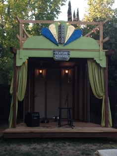 an outdoor stage set up with curtains and lights