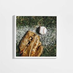 a baseball and glove laying on the grass