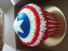 a red, white and blue cupcake in a box