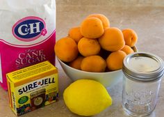 oranges, sugar, and other ingredients are sitting on the counter next to a bag of cane sugar