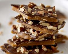 chocolate and nuts are stacked on top of each other in the middle of a white plate