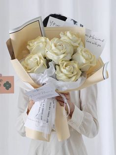 a woman holding a bouquet of flowers in her hands with congratulations cards on the side