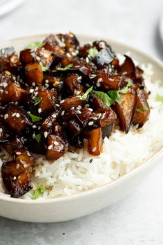 a white bowl filled with rice and meat