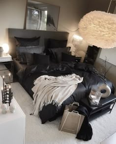 a black and white bedroom with candles on the nightstands