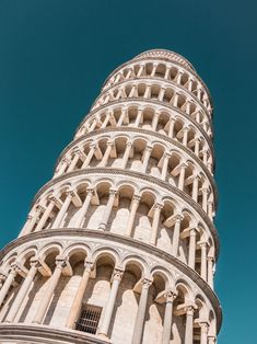 the leaning tower is very tall and has many arches on it's sides,