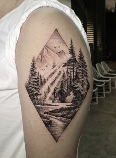 a man with a mountain landscape tattoo on his arm