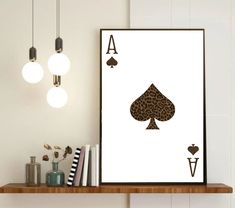 an ace card print hangs on the wall next to a shelf with books and other items