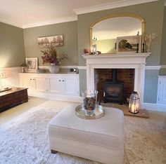 a living room filled with furniture and a fire place next to a couch in front of a fireplace