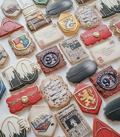 some cookies are laying on top of each other in different shapes and sizes, all decorated with royal emblems