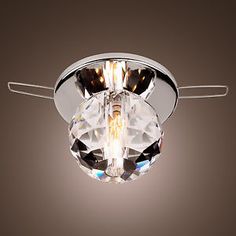 a light that is on the ceiling with a brown wall in front of it and a black background