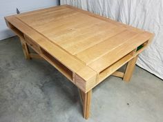 a wooden table sitting on top of a cement floor