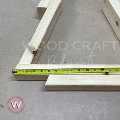 the wooden frame is being built with tape measure and woodworking tools on the floor