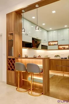 a kitchen with two bar stools in front of it and a wine rack on the wall